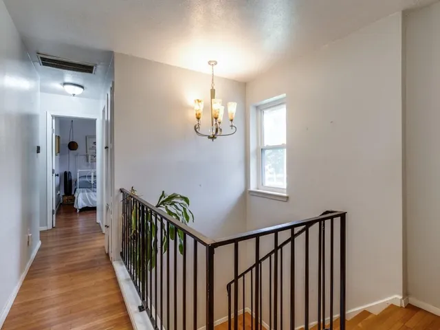 a view of a hallway with windows