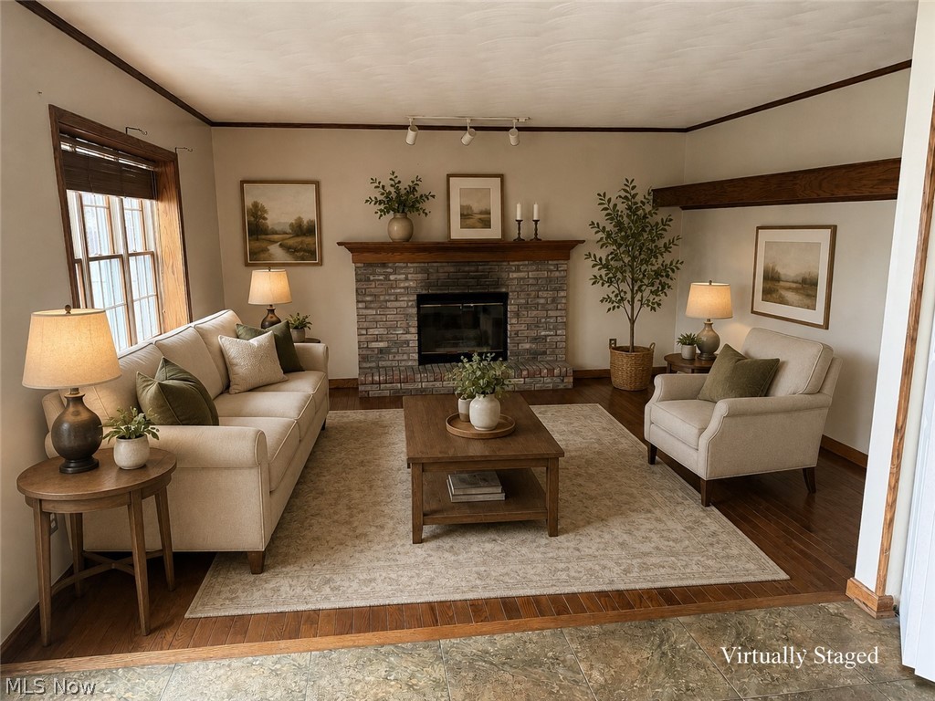 6416 Ridgeview Avenue Youngstown, OH 44515 - Photo 3 of 15 Living area featuring a brick fireplace with a wood mantle, wood-finish flooring, and exposed wood ceiling beam