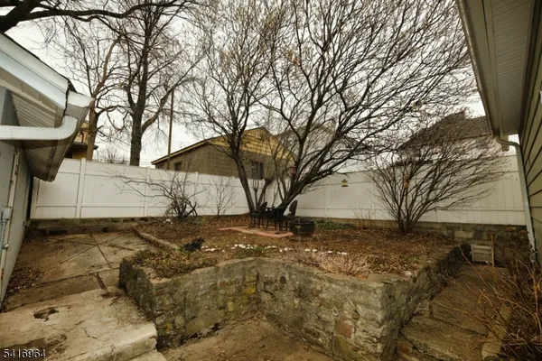 a view of a yard with large trees