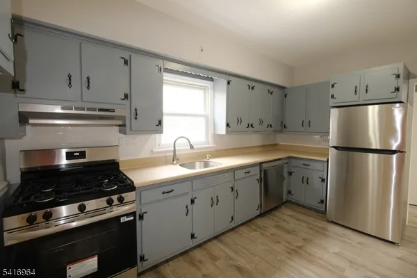 a kitchen with cabinets appliances and a window