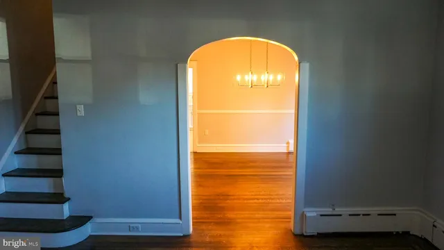 a view of a room with wooden floor and a window