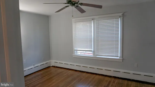 a view of a room with a window and a ceiling fan