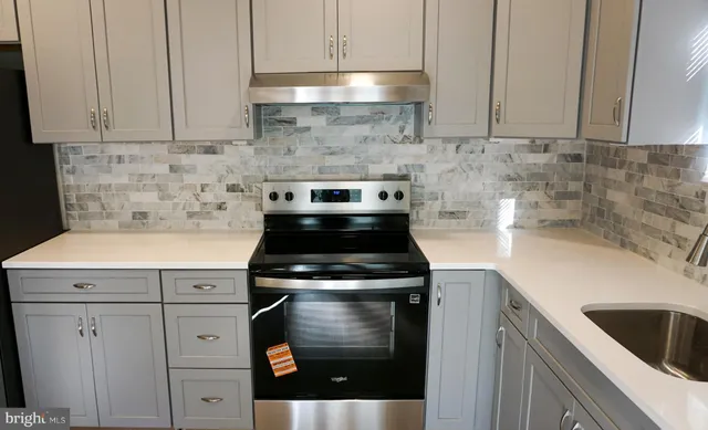 a kitchen with cabinets appliances and a sink