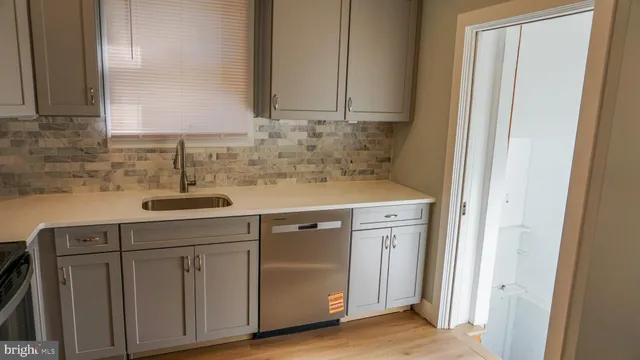 a sink with white cabinets