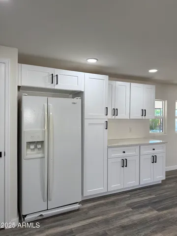 a view of kitchen with stainless steel appliances refrigerator sink and cabinets
