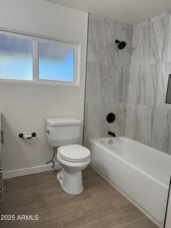 a bathroom with a toilet a sink and bathtub