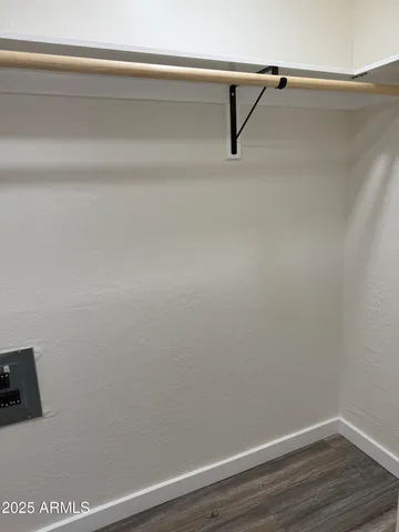 a view of a closet with wooden floor