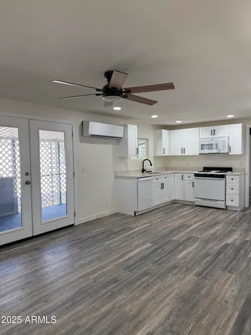 a view of a kitchen with a sink wooden cabinets and a window
