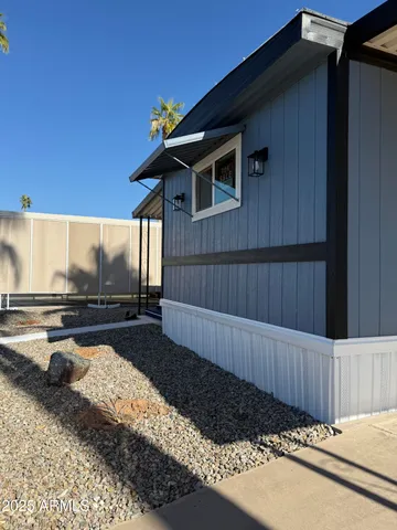 a view of a wooden house with a yard