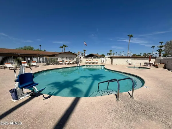 a swimming pool with outdoor seating and yard