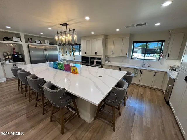a large kitchen with a table and chairs