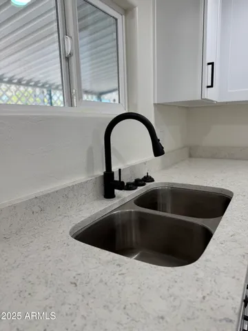 a kitchen with a sink and a window