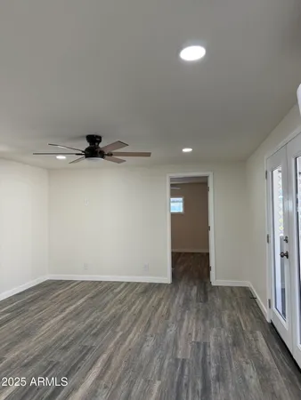 a view of an empty room with wooden floor