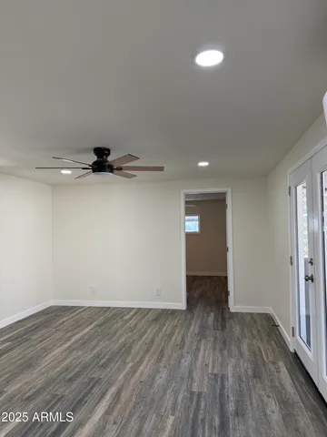 a view of an empty room with wooden floor