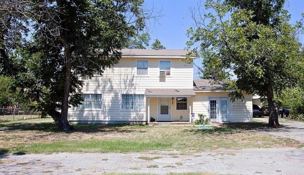 1115 Old Jacksboro Road Graham, TX 76450 - Photo 1 of 15 a front view of a house with a garden