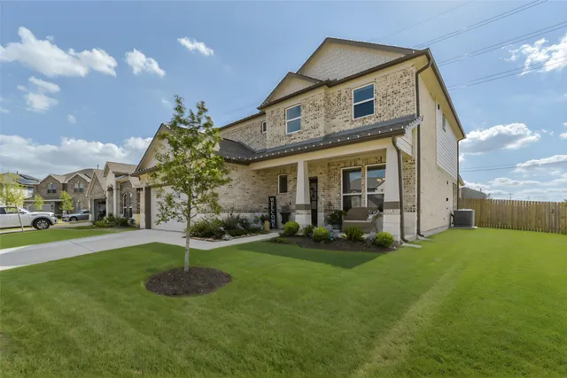 a front view of a house with garden