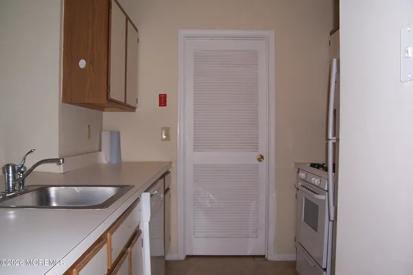 a kitchen with a sink and a refrigerator