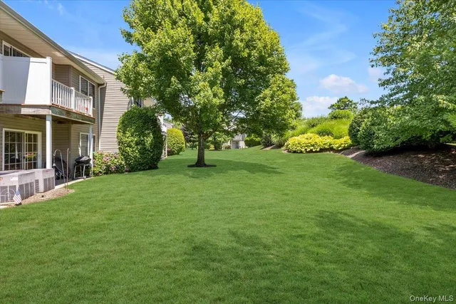 a view of a garden with a building in the background