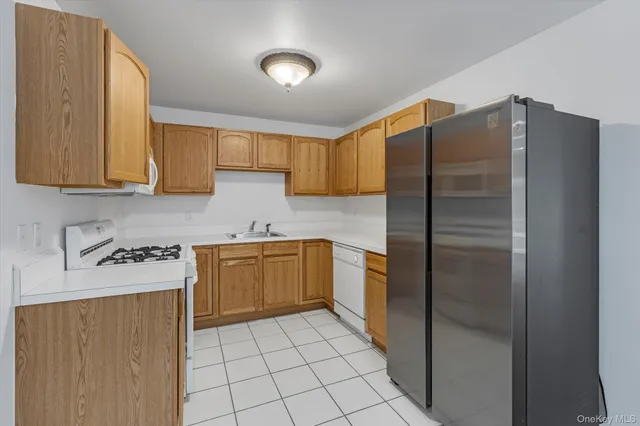 a kitchen with stainless steel appliances granite countertop a refrigerator and a stove