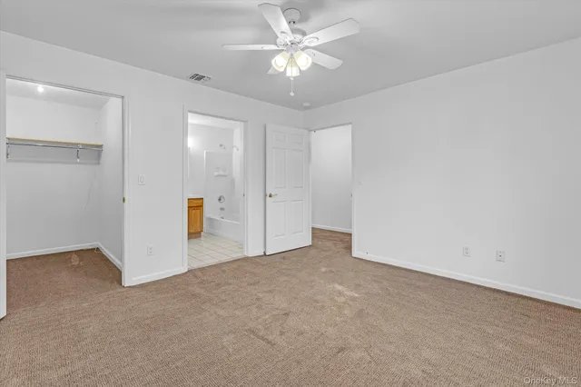 an empty room with fan and a fan