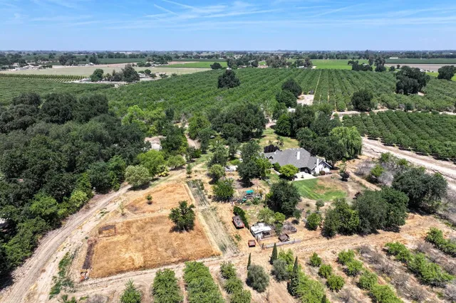 a view of a city with green field