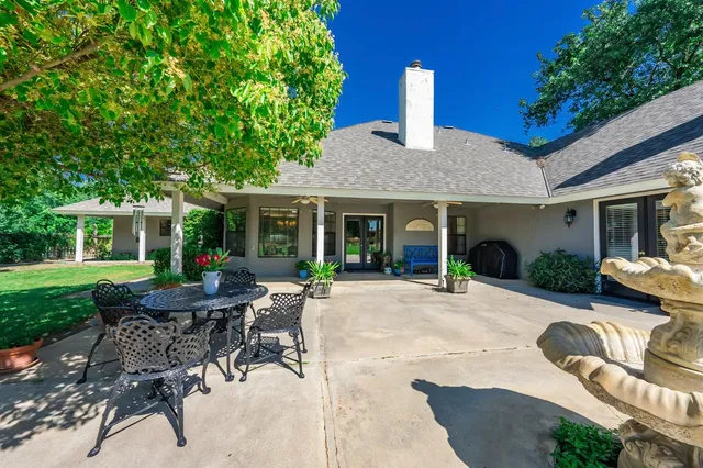 a house view with a sitting space and garden