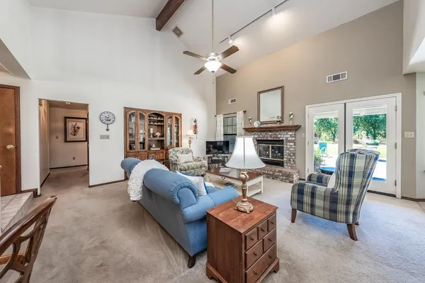 a living room with fireplace furniture and a wooden floor