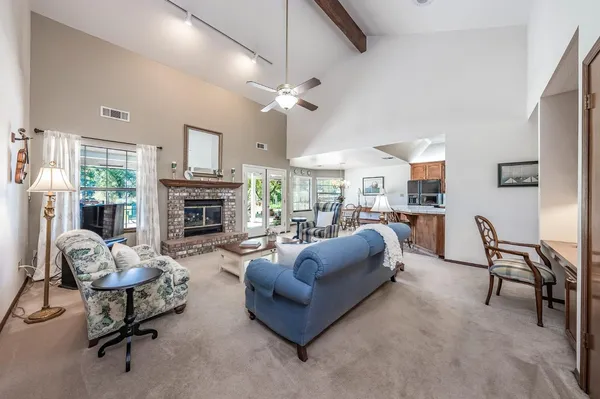 a living room with furniture and a fireplace