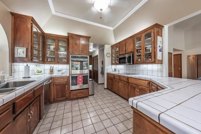 a kitchen with stainless steel appliances granite countertop a sink and cabinets