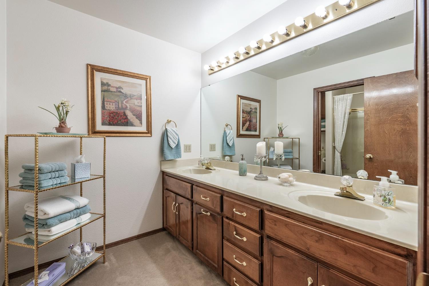 9415 21st Avenue Lemoore, CA 93245 - Photo 30 of 36 a bathroom with a double vanity sink and a mirror
