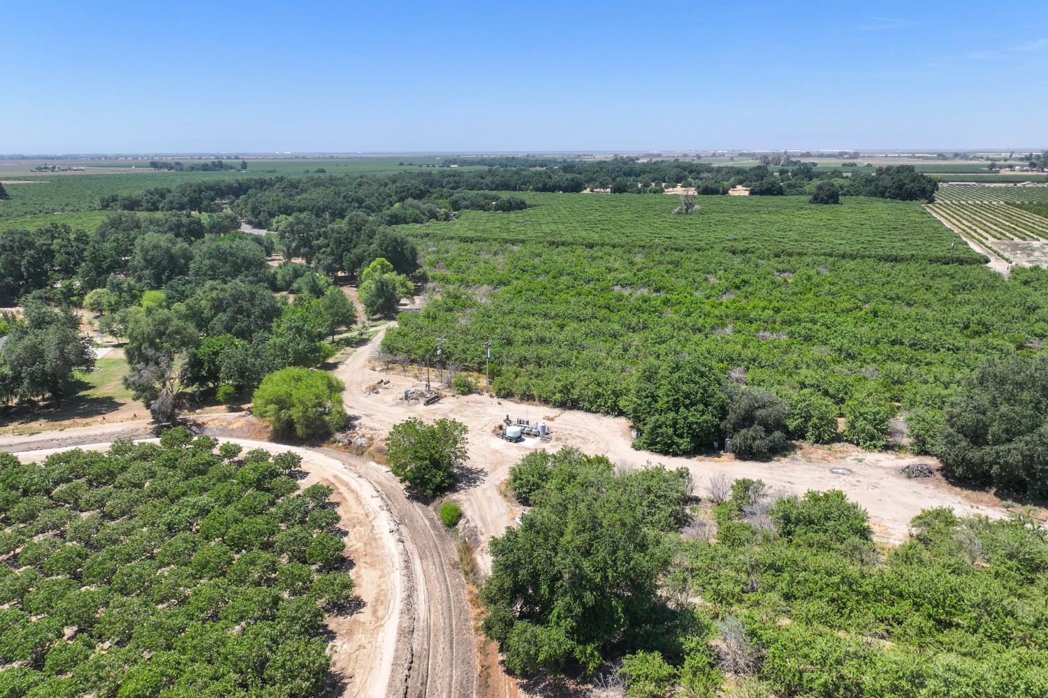 9415 21st Avenue Lemoore, CA 93245 - Photo 4 of 36 an aerial view of green landscape with trees houses and mountain view