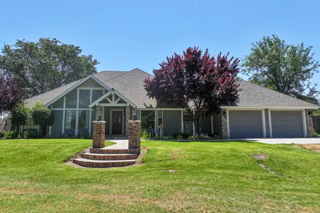 a front view of house with yard and green space
