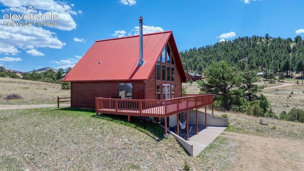 489 Excelsior Road Westcliffe, CO 81252 - Photo 30 of 34 a view of a backyard with a small cabin and wooden fence