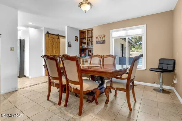 a view of a dining room with furniture and a window