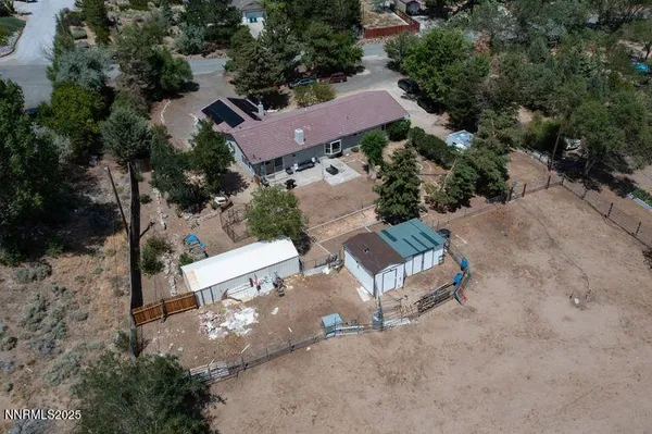 an aerial view of a house with a yard and garden