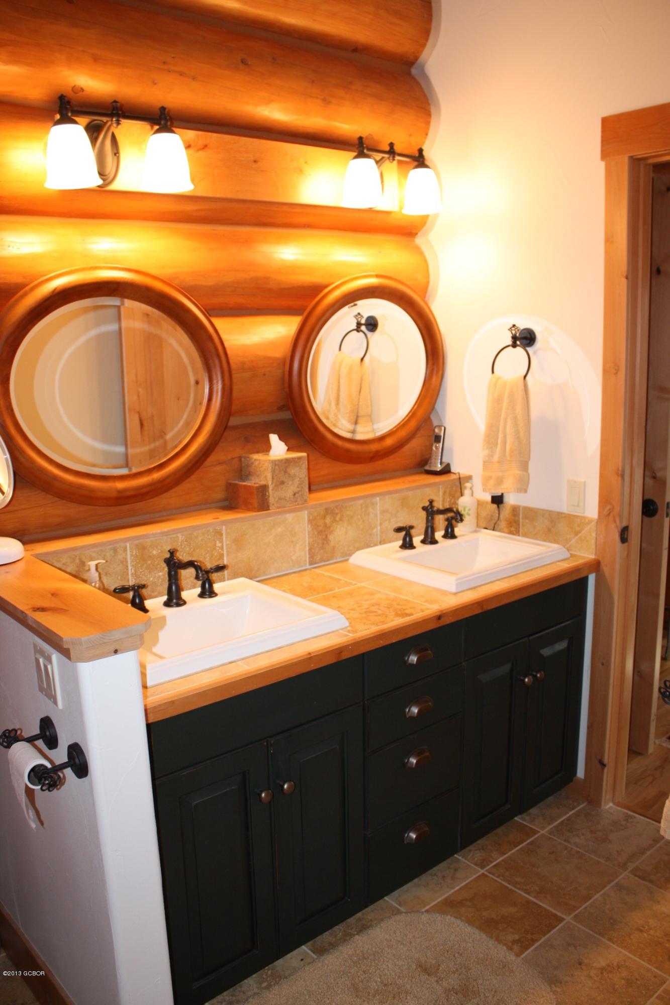 763 County Road Granby, CO 80446 - Photo 21 of 31 a bathroom with a double vanity sink and mirror