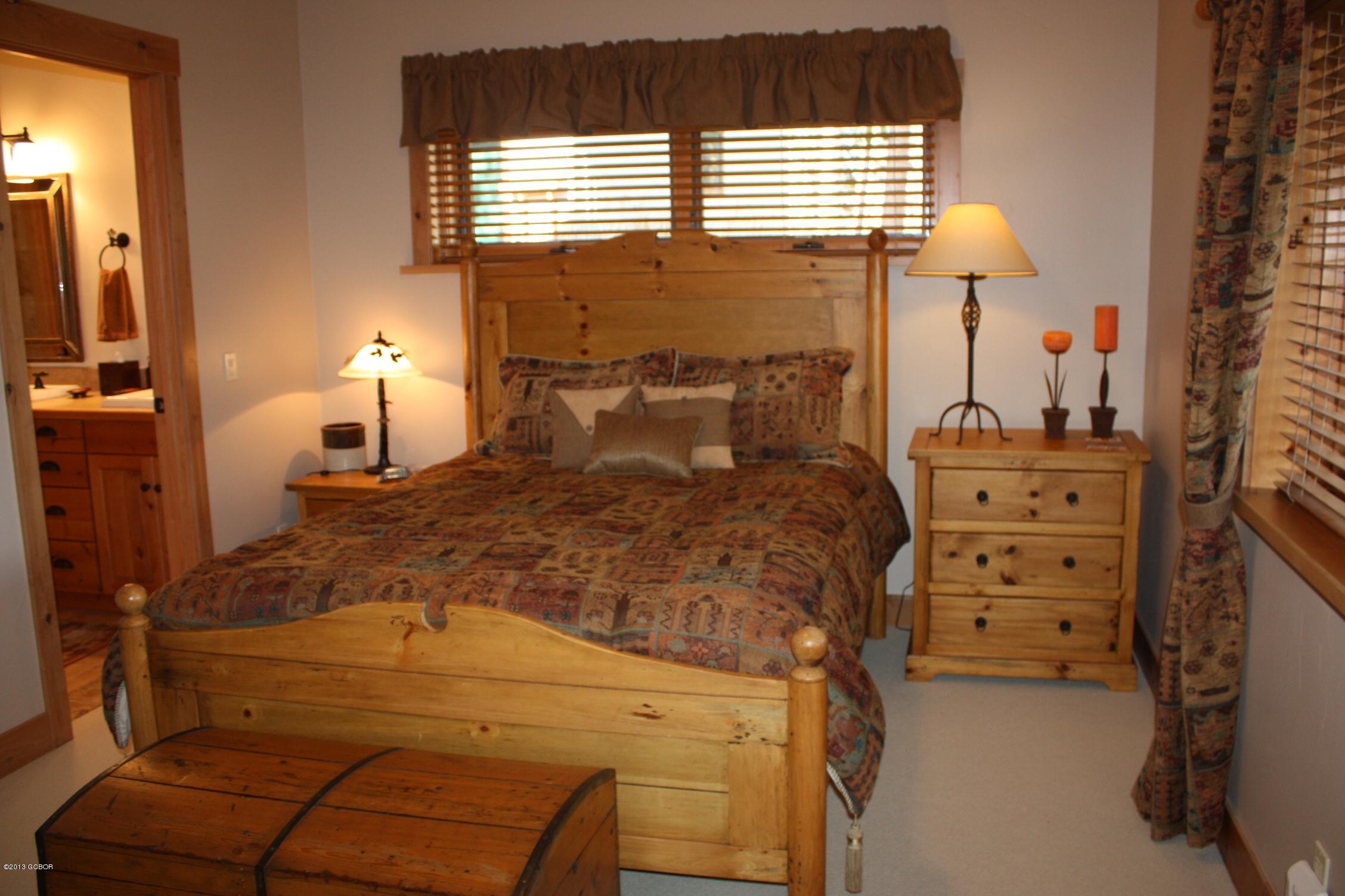 763 County Road Granby, CO 80446 - Photo 23 of 31 a bed room with a bed and a lamp