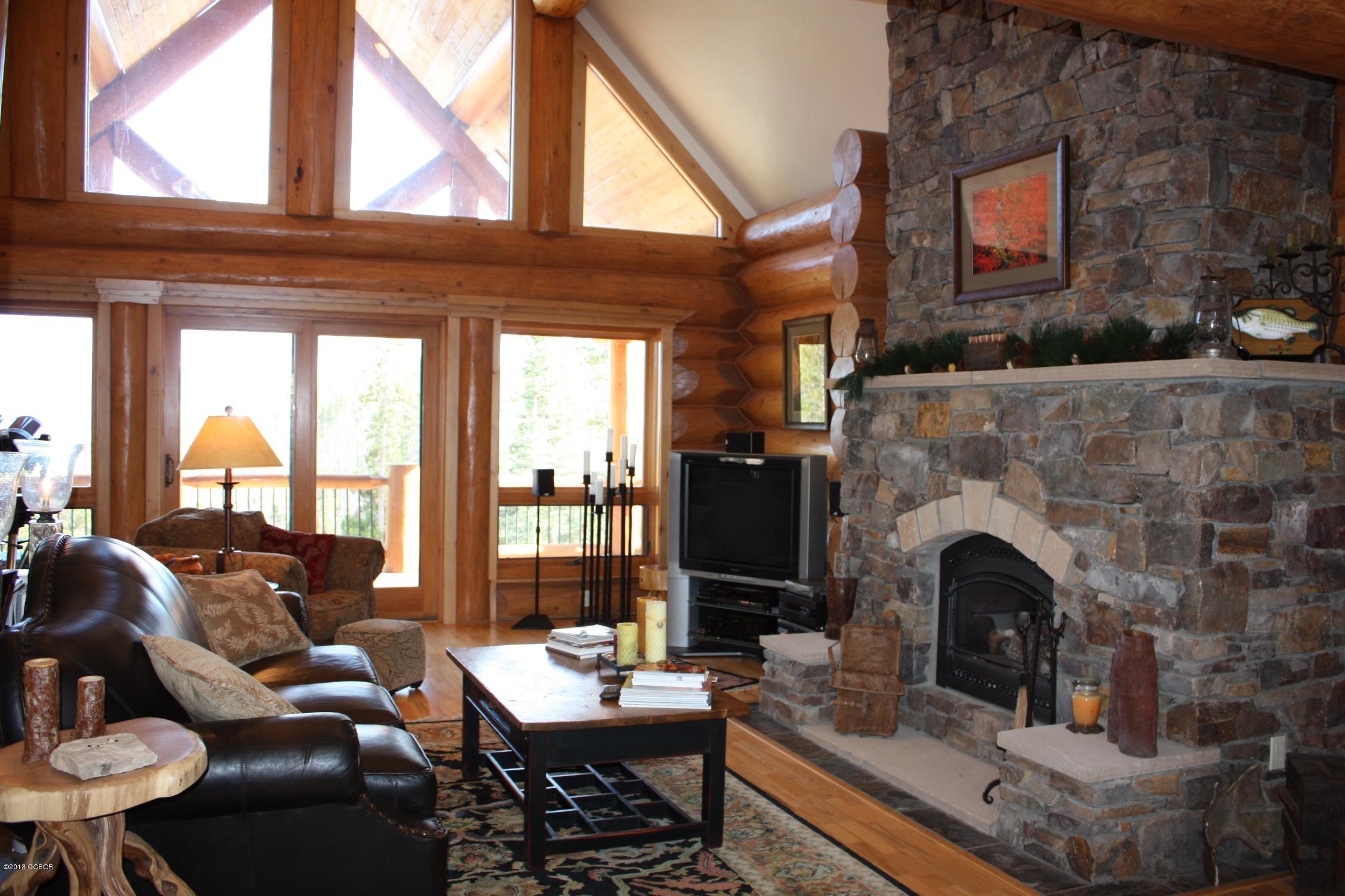 763 County Road Granby, CO 80446 - Photo 8 of 31 a living room with furniture a fireplace and a large window