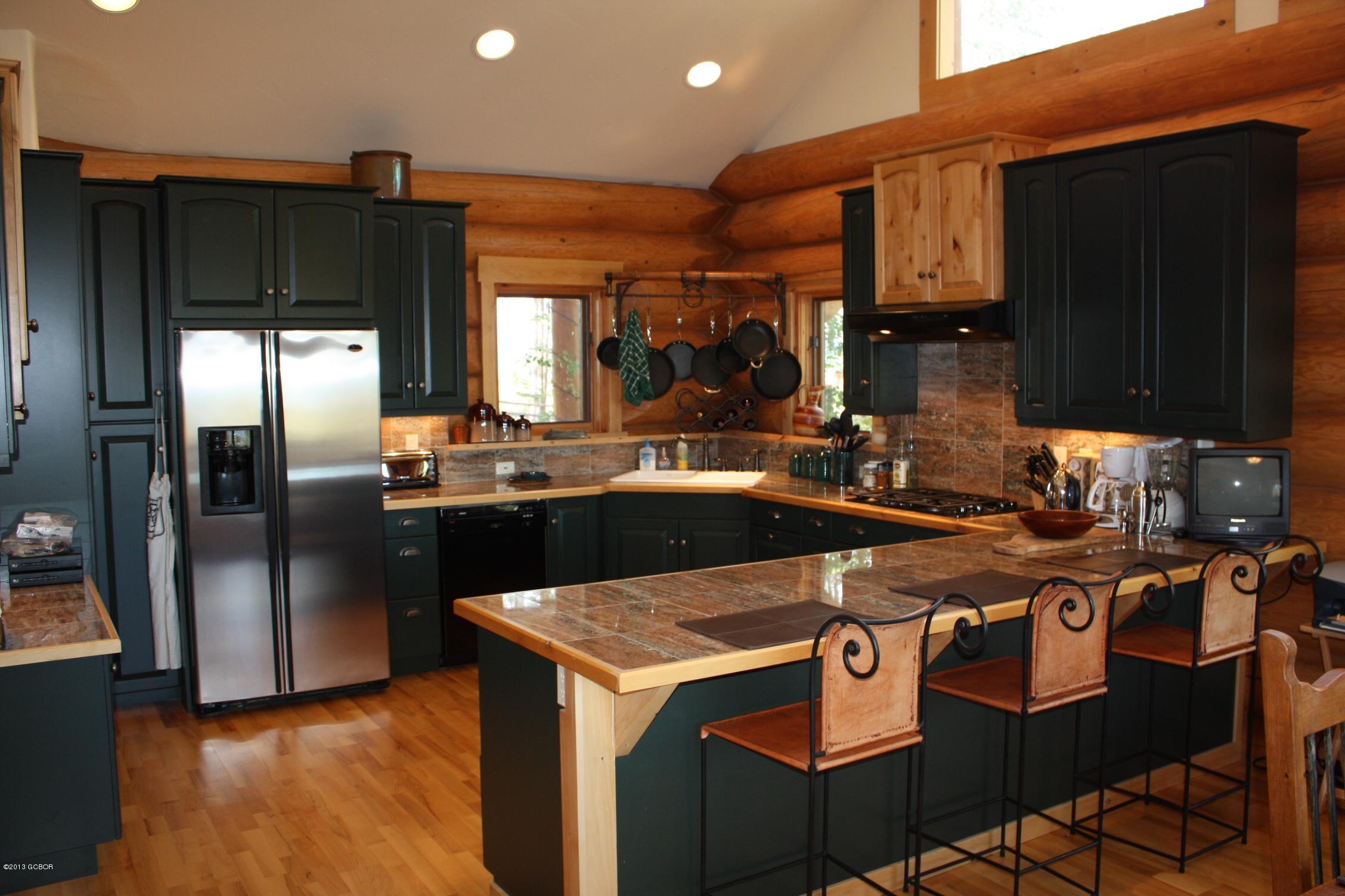 763 County Road Granby, CO 80446 - Photo 10 of 31 a kitchen with stainless steel appliances granite countertop a sink a stove and a refrigerator