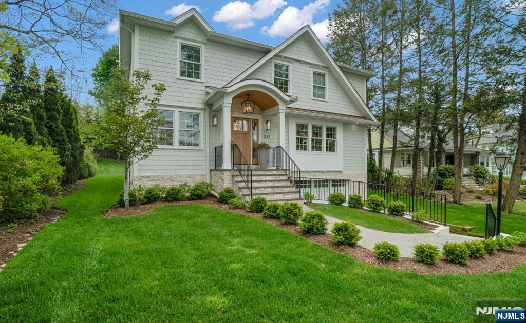331 Wastena Terrace Ridgewood, NJ 07450 - Photo 1 of 49 a front view of a house with a garden