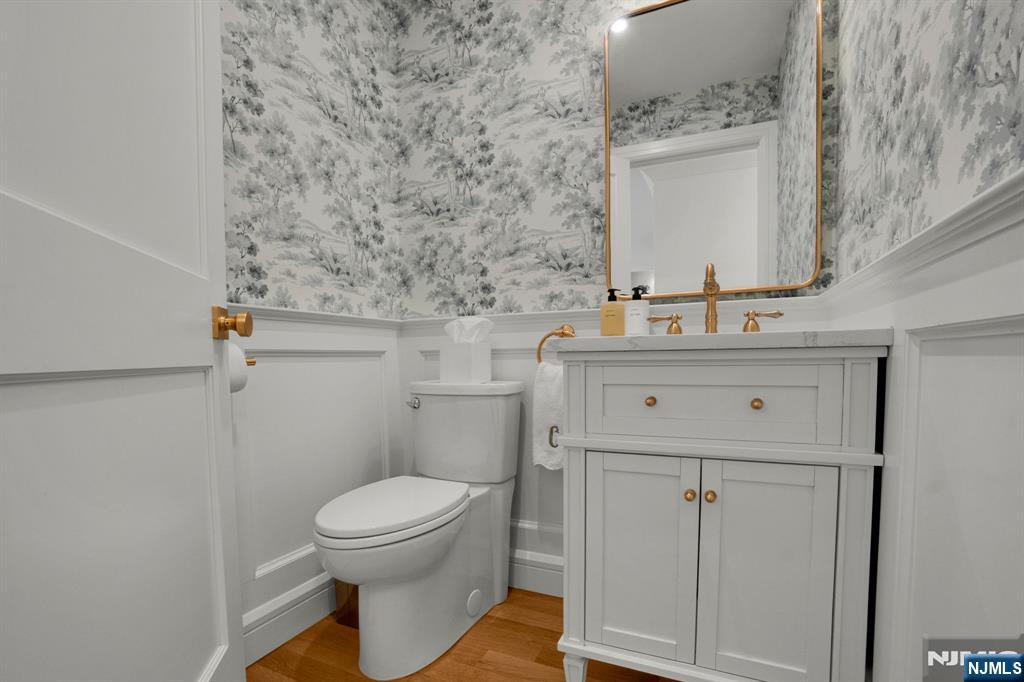 331 Wastena Terrace Ridgewood, NJ 07450 - Photo 23 of 49 a bathroom with a toilet sink and mirror