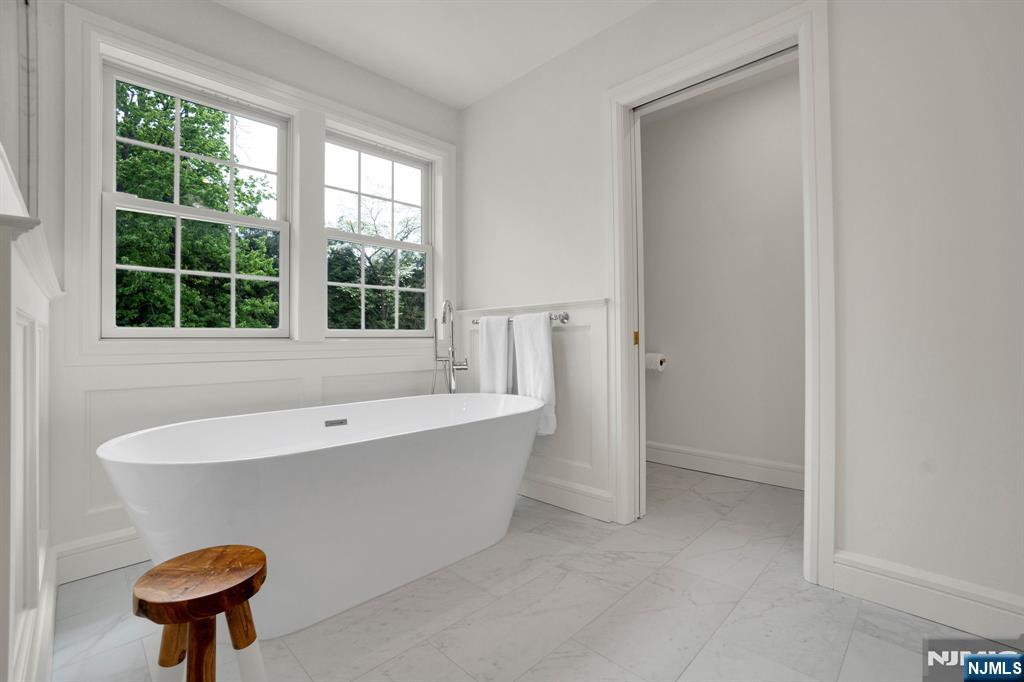 331 Wastena Terrace Ridgewood, NJ 07450 - Photo 28 of 49 a bathroom with a tub and a window