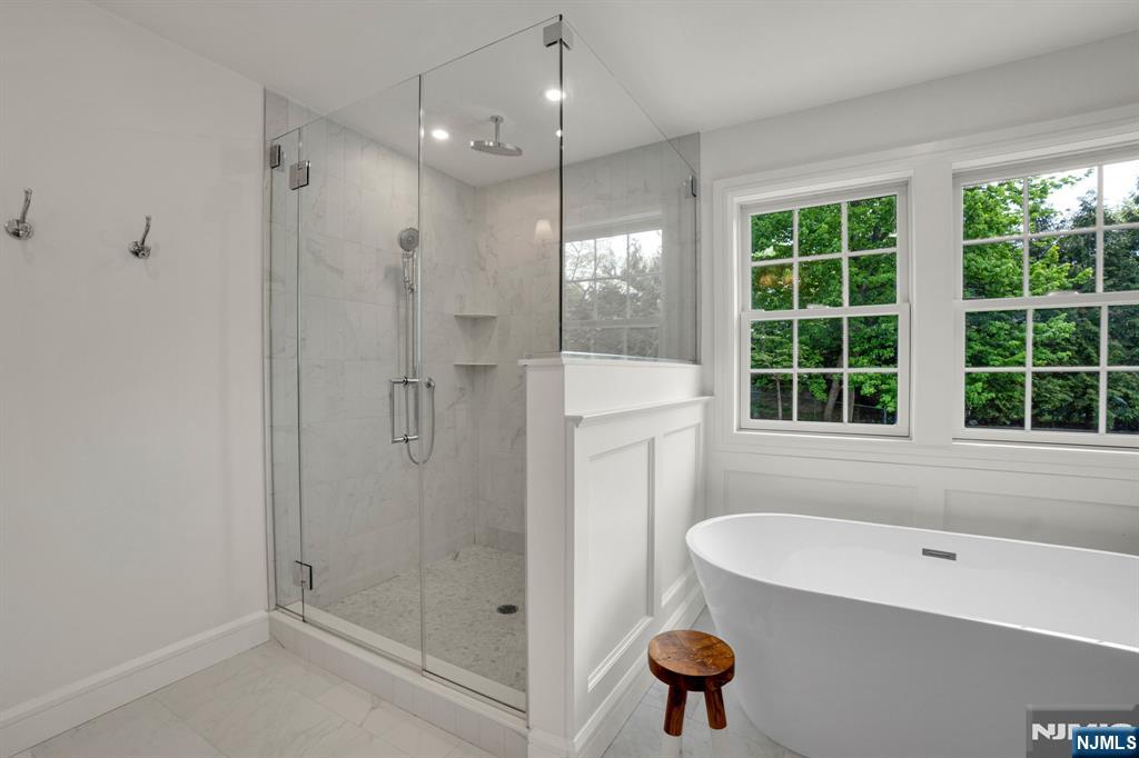 331 Wastena Terrace Ridgewood, NJ 07450 - Photo 30 of 49 a bathroom with a tub a sink and a shower