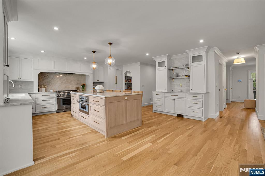 331 Wastena Terrace Ridgewood, NJ 07450 - Photo 3 of 49 a large white kitchen with a large counter top stainless steel appliances and cabinets