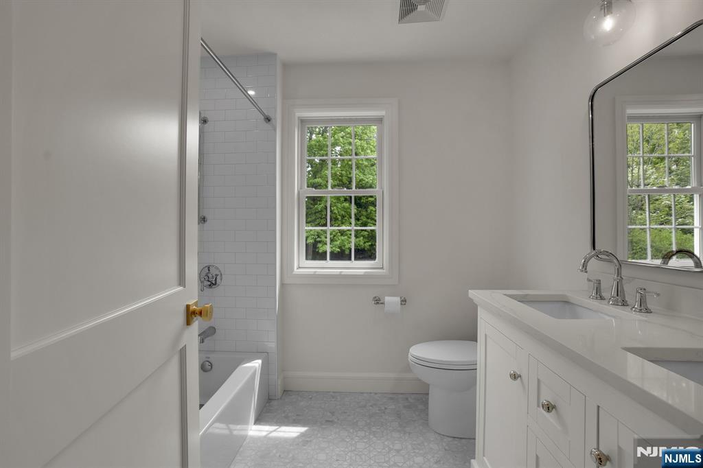 331 Wastena Terrace Ridgewood, NJ 07450 - Photo 35 of 49 a bathroom with a granite countertop sink toilet and shower