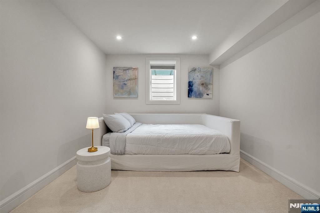 331 Wastena Terrace Ridgewood, NJ 07450 - Photo 39 of 49 a bedroom with a bed and a couch