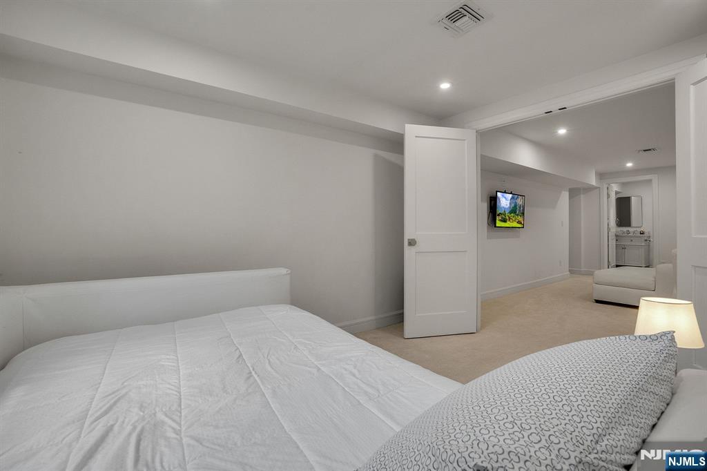 331 Wastena Terrace Ridgewood, NJ 07450 - Photo 41 of 49 a bedroom with a bed and a couch