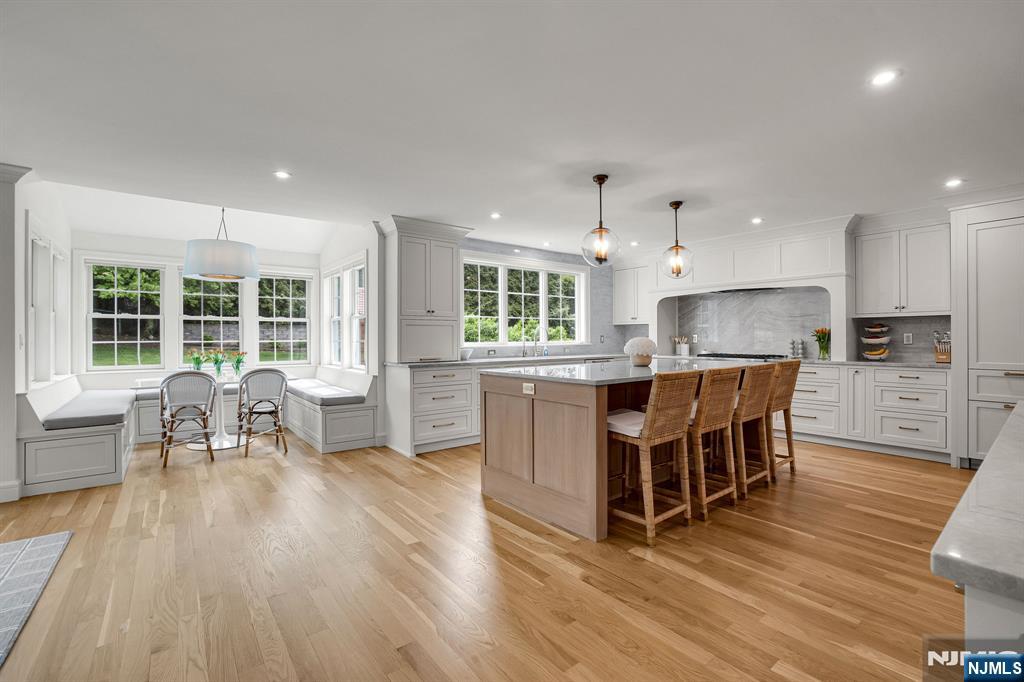 331 Wastena Terrace Ridgewood, NJ 07450 - Photo 5 of 49 a kitchen with kitchen island granite countertop a sink counter and chairs