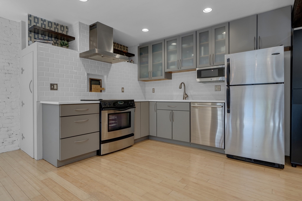 9 Appleton Street, Unit M1 Boston, MA 02116 - Photo 11 of 24 a kitchen with stainless steel appliances a refrigerator sink and cabinets