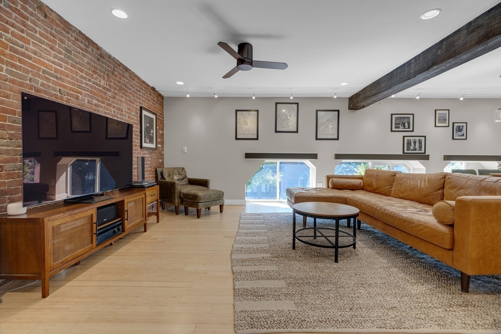 9 Appleton Street, Unit M1 Boston, MA 02116 - Photo 2 of 24 a living room with furniture and a flat screen tv